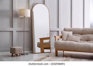 Light room interior with large mirror near wall