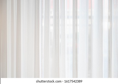 Light and see through concept, Classic white sheer curtains hanging by the window in the room with blurred view outside as background. - Shutterstock ID 1617542389