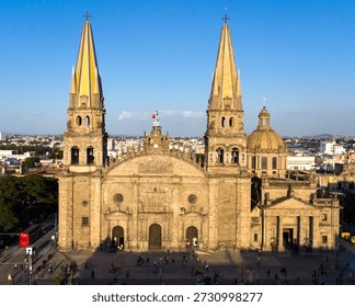 The light of the setting sun highlights the facade of the Guadalajara cathedral