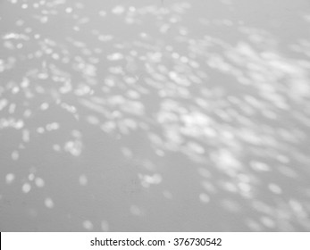 light and shadow bokeh on white wall