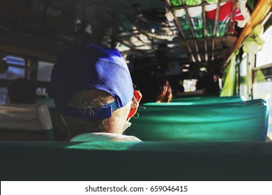 Light And Shadow Concept. Old Man On The Bus With Over Sunlight And Soft-focus In The Background