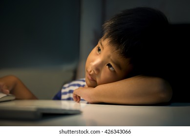 Light And Shadow Of Kid With Computer.