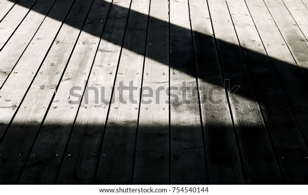Light and shadow on old\
wood floor.