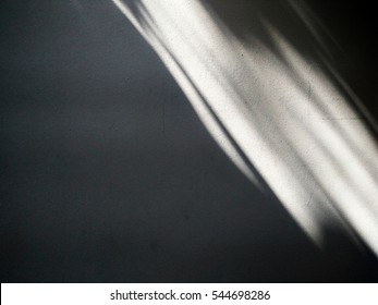 Light and shadow on wall for background.