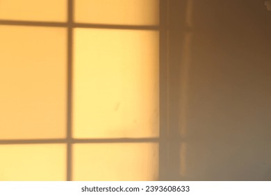 Light and shadow from window on wall