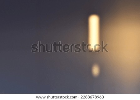 Light shaped exclamation mark transmuting sunset lights onto white matt tiles