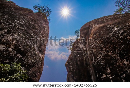 the light shine down through the mountain gap, you can see the multiple layers of rock walls. this cave is very ancient, North of Thailand.