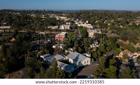 Light shines on historic structures in downtown Auburn, California, USA.