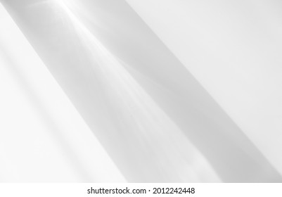 The light shines on the white background photo, the shadow lines from the curtain, blurry shadows and silates on the wall. Mockup, copy space. - Shutterstock ID 2012242448
