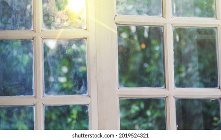 Light Shines Through A White Window Outside Blurry Natural Background.