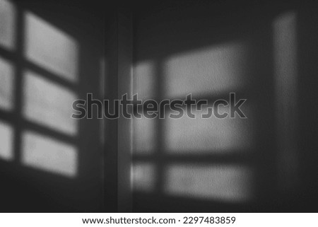 Light shines through the window into the dark corners of the room. Black and white background for abstract concept.