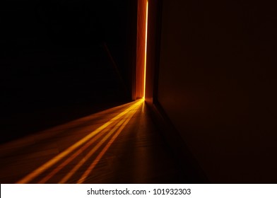 Light Shining On The Floor Through Door Gap