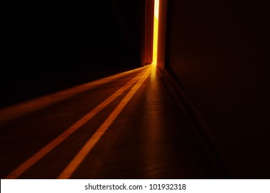 Light Shining On The Floor Through Door Gap