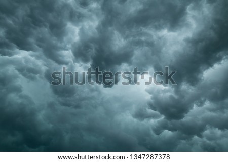 Light shining through the bottom of turbulent storm clouds