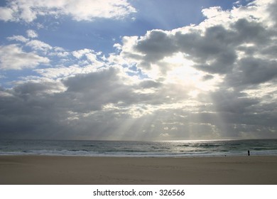 light shining through the clouds on beach