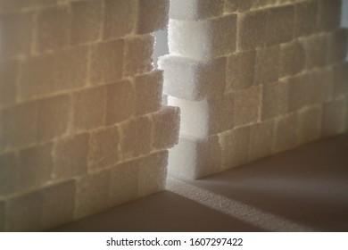 Light Shining Through Gap In A Wall Made Out Of Sugar Cubes, Symbolizing The Needed Change From Unhealthy To Healthy Food