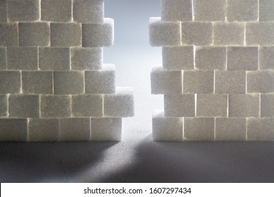 Light Shining Through Gap In A Wall Made Out Of Sugar Cubes, Symbolizing The Needed Change From Unhealthy To Healthy Food