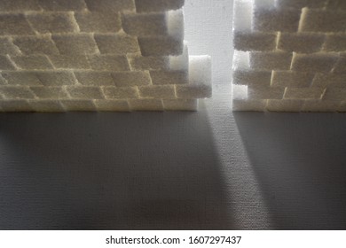 Light Shining Through Gap In A Wall Made Out Of Sugar Cubes, Symbolizing The Needed Change From Unhealthy To Healthy Food