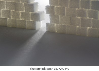 Light Shining Through Gap In A Wall Made Out Of Sugar Cubes, Symbolizing The Needed Change From Unhealthy To Healthy Food