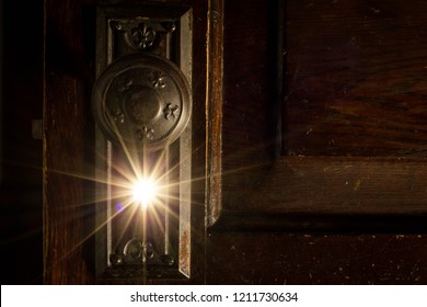 Light Shining Through Key Hole Of Old Door