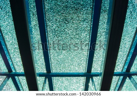 Light shining through a piece of broken tempered glass leaning against an easel