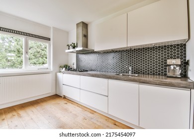 Light Small Home Kitchen With Wide Window Furnished With Cupboards And Shelves With Appliances In Modern Urban Apartment