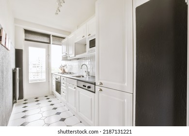 Light Small Home Kitchen With Wide Window Furnished With Cupboards And Shelves With Appliances In Modern Urban Apartment