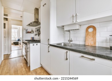 Light Small Home Kitchen With Wide Window Furnished With Cupboards And Shelves With Appliances In Modern Urban Apartment