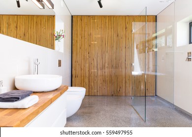 Light And Spacious Bathroom With Walk In Shower, Mirror, Wooden Worktop With Basin And Wood Wall Divider