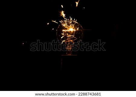 Light and sparks from a burning incandescent lamp. Short circuit