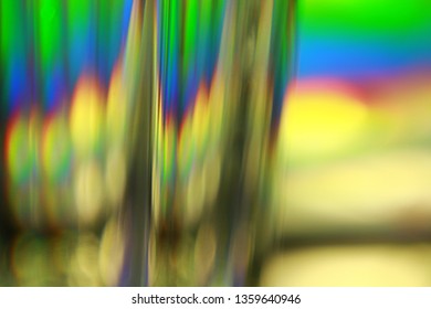 Light split into colours by a glass surface. Close up of glass with light interference effect, color diffraction. Transparent optical element that refract light.