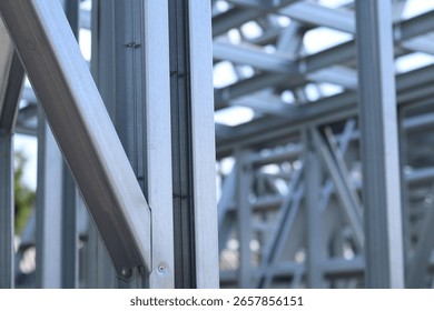 Light steel thin-walled structures. Frames for warehouses, garages and houses. Steel frame construction for construction. Details. Light steel frame fragment close-up. Construction concept