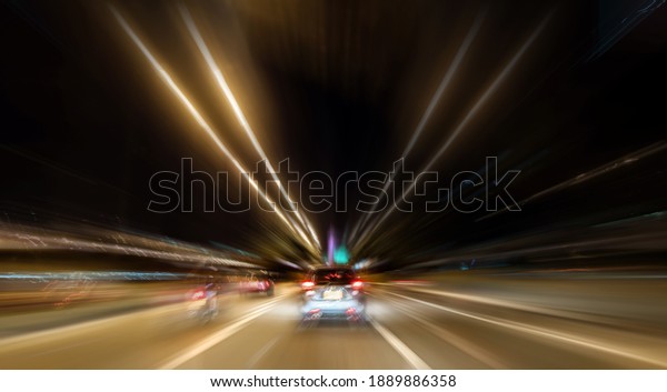Light streaks drawn due to the movement at a\
great speed on the road by a car at\
night