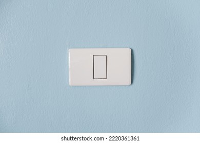 Light Switch Button On The Blue Cement Wall. Energy Use In Home. Electricity Consumption.