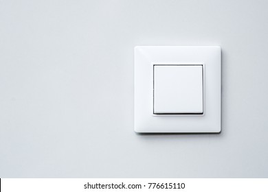 a light switch, a plastic mechanical switch of white color installed on a light gray wall. - Shutterstock ID 776615110