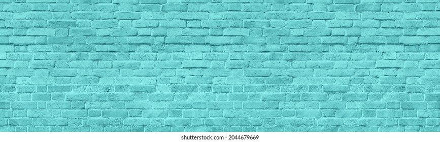 Light teal old shabby brick wall wide panoramic texture. Turquoise painted rough brickwork panorama. Pastel blue abstract widescreen background