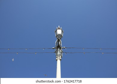 Light And Telephone Poll With Blue Sky