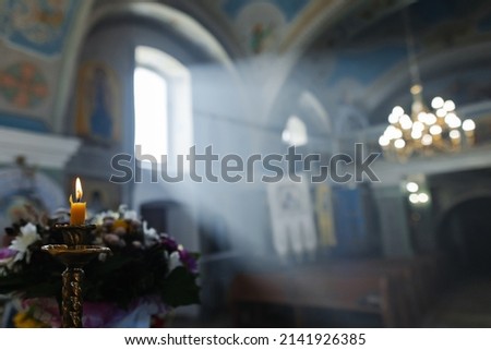 Light through the window to the church. Memory candle. holy light. Box of essential oils. Holy water. Gospel.