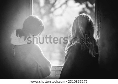 Similar – Image, Stock Photo Twin sisters sitting with their backs to the camera
