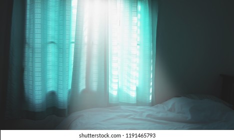 Light through windows and blue curtains.