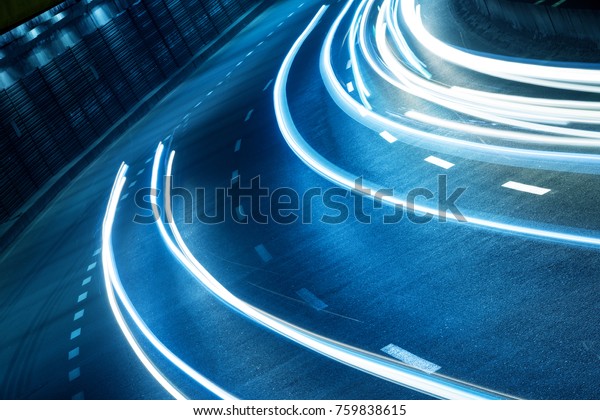 Light track of\
moving cars in a dark\
tunnel