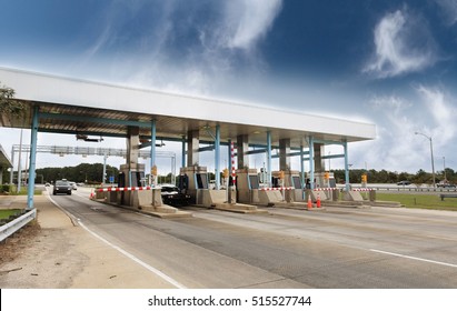 Light traffic at toll plaza under blue sky. - Shutterstock ID 515527744