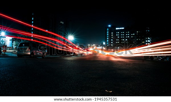 LIGHT TRAIL OF\
CARS OF A BUSY STREET AT\
NIGHT