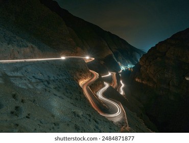 light trail of a moving vehicle on a winding road in Dades Gorge, Morocco                                - Powered by Shutterstock