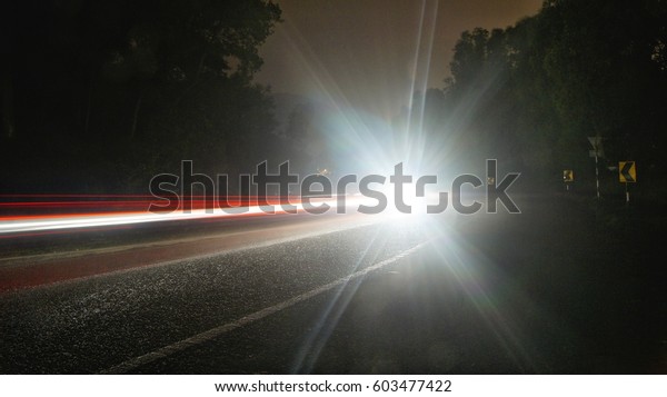 Light trail on dark\
road mountain valley