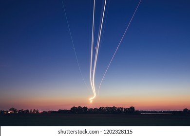 Light trails of airplane during landing at airport after sunset. Prague, Czech Republic. - Powered by Shutterstock