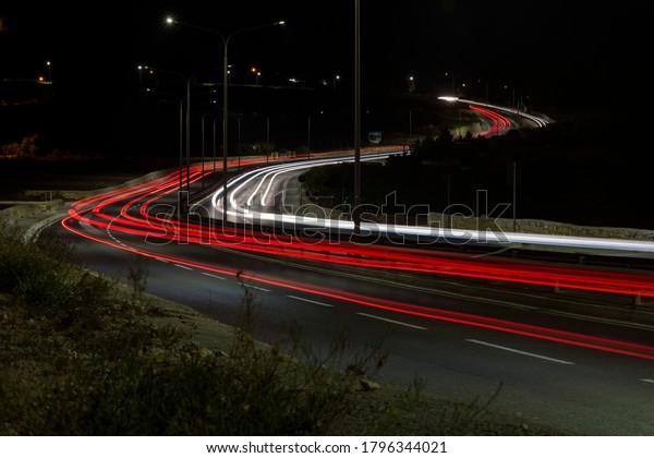 Light trails of cars on\
a busy street.