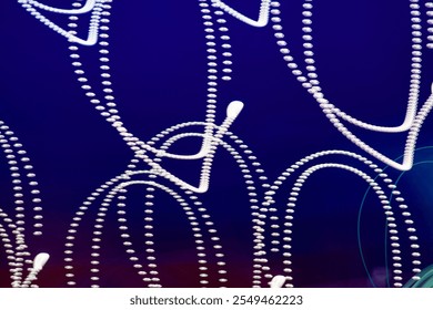 Light trails composed of small dots create visually engaging loops against a dark-to-red gradient background, perfect for creative and abstract projects.