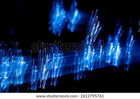 Light trails creating a wavy pattern resembling an oscillating signal or sound wave, perfect for projects related to technology, music, or energy
