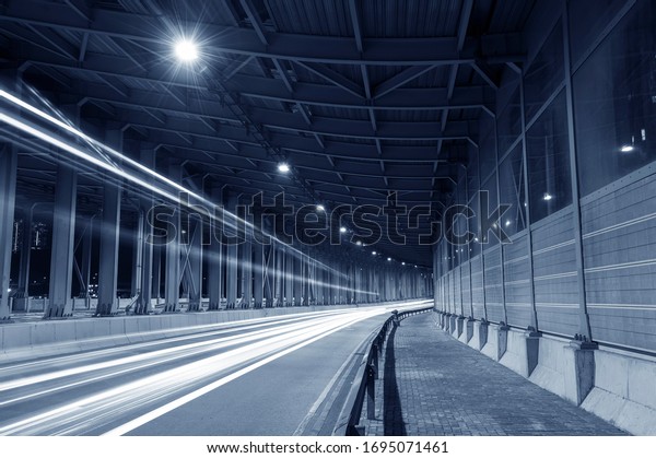 light trails and head lights of traffic in\
tunnel. Transportation\
background